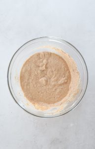 Mini crab cake batter mixed in a glass bowl before adding crab meat