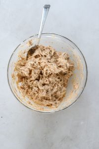 Fully mixed mini crab cake batter showing shredded crab and creamy texture