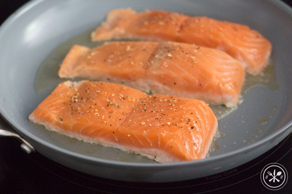 Raw salmon in pan