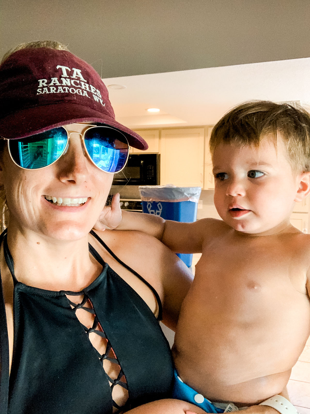 mom and baby in swim suits close up in kitchen