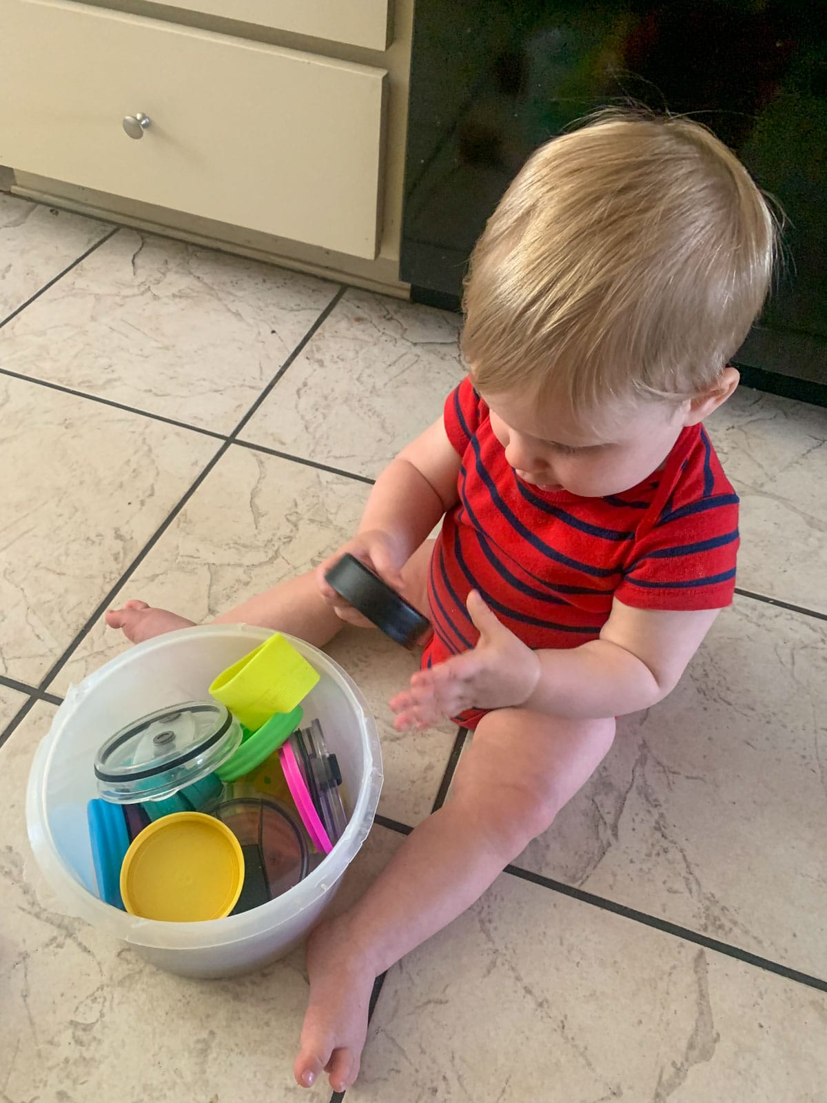 baby playing with tupperware