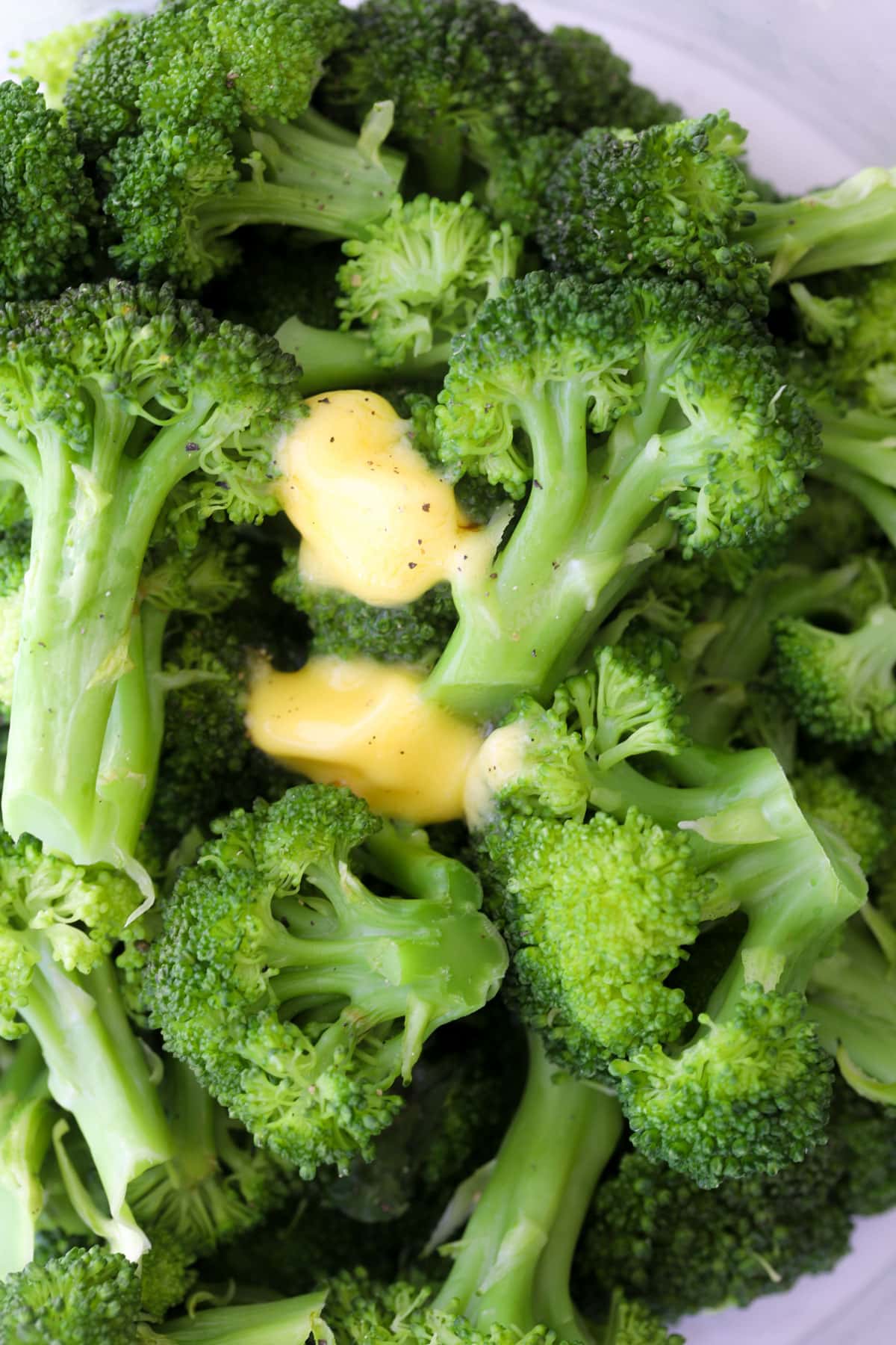 A quick and simple way to steam broccoli in the microwave in less than five minutes, add extra flavor, and you don't need plastic wrap!