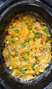 Crockpot crack chicken served from slow cooker with bacon, cheddar, and green onion